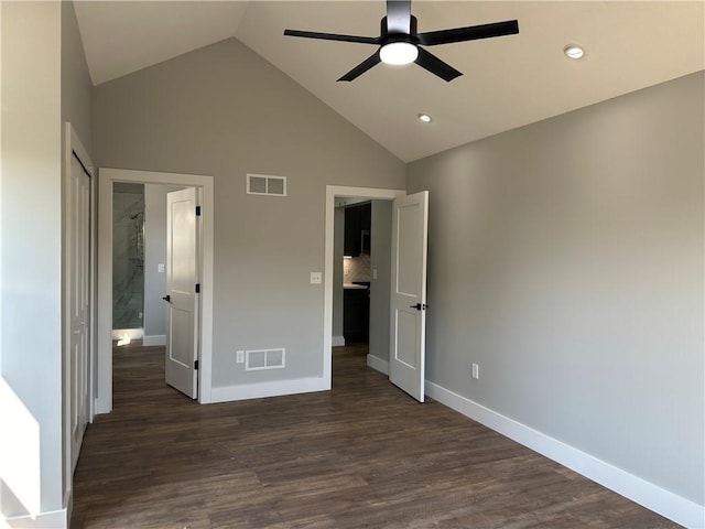 unfurnished bedroom featuring ceiling fan, dark wood-type flooring, and high vaulted ceiling