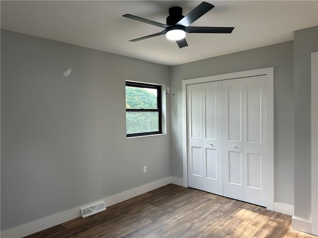 unfurnished bedroom with a closet, ceiling fan, and hardwood / wood-style flooring