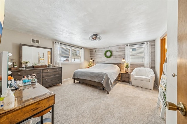 carpeted bedroom with wooden walls