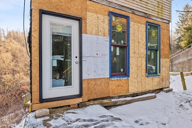 view of snow covered property entrance