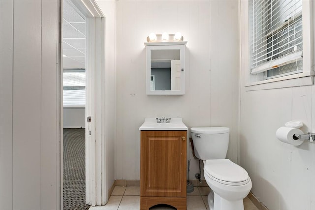 bathroom featuring tile patterned flooring, vanity, and toilet