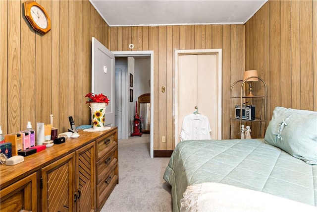 carpeted bedroom featuring a closet and wooden walls