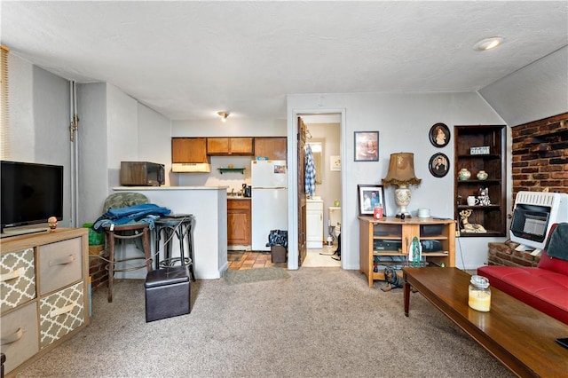 carpeted living room with heating unit, a textured ceiling, and vaulted ceiling