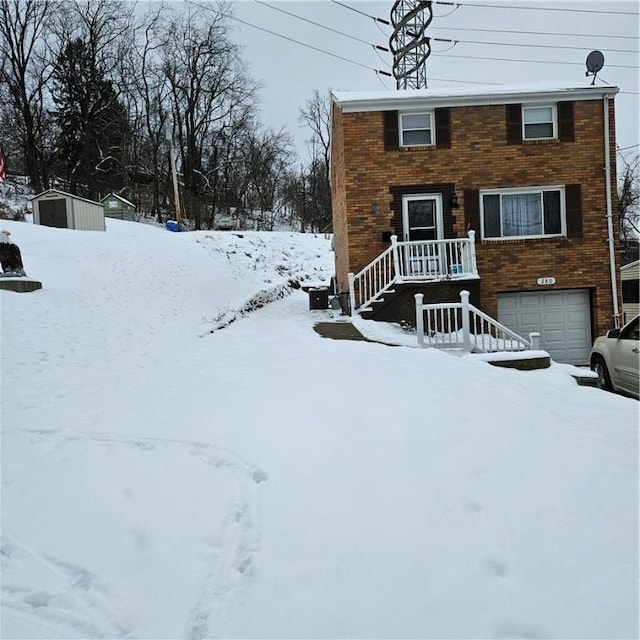 view of front facade featuring a garage and a storage unit