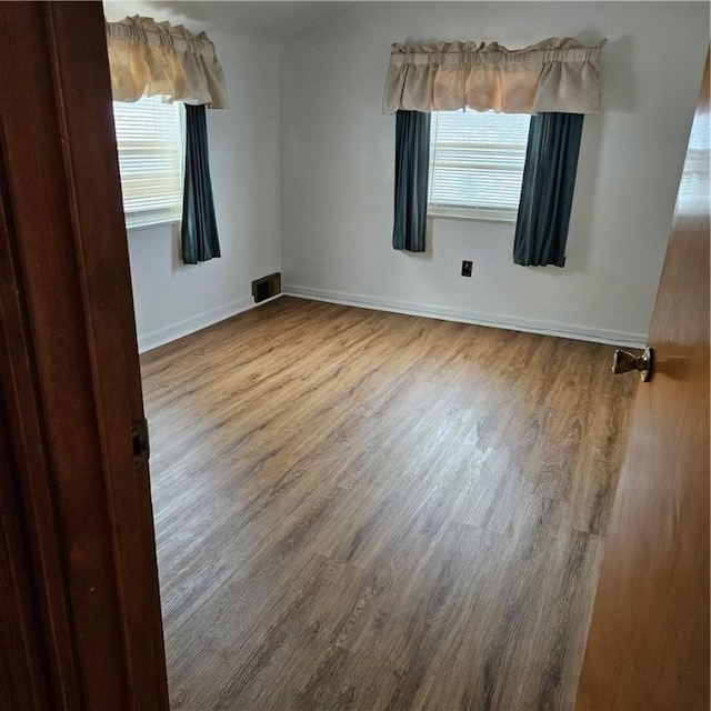 unfurnished room featuring wood-type flooring