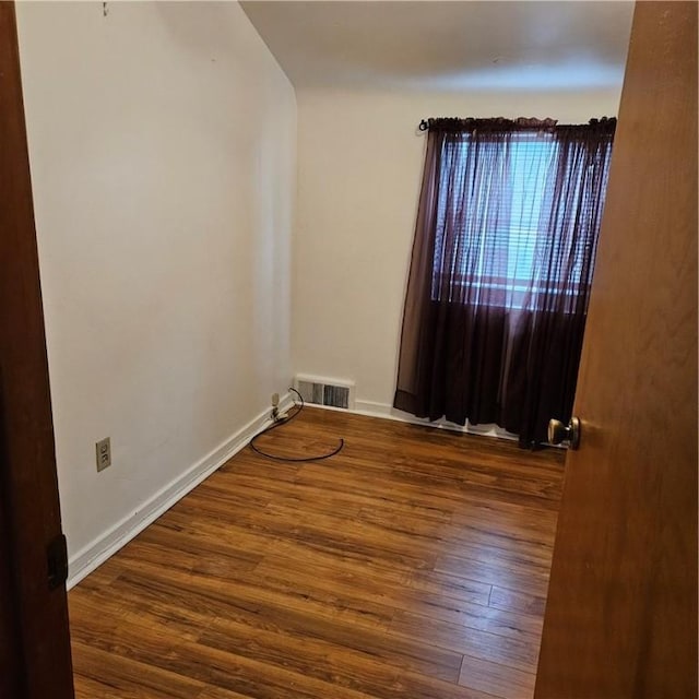 unfurnished room with dark hardwood / wood-style floors