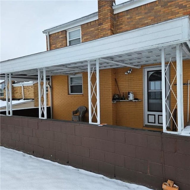 view of snow covered rear of property