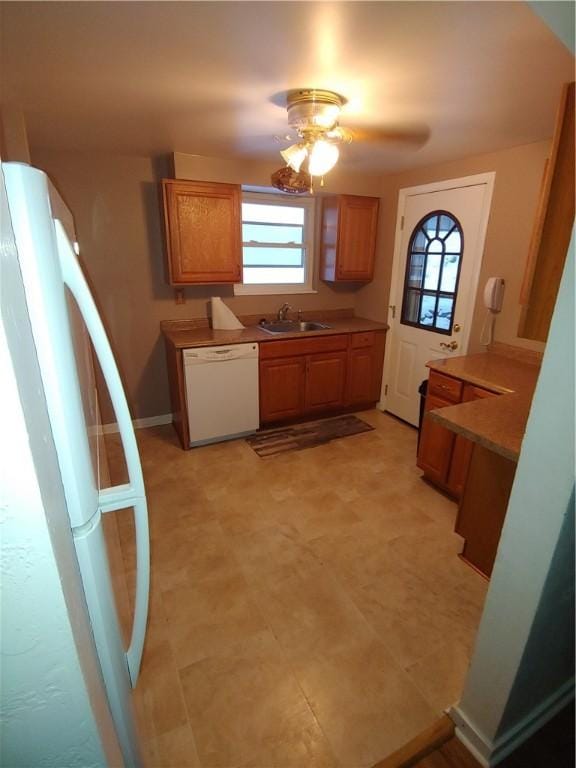 kitchen with ceiling fan, white appliances, and sink