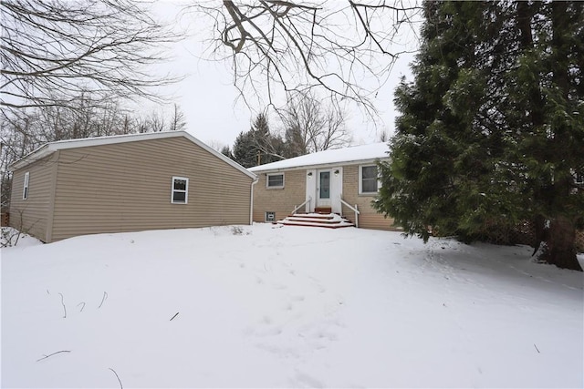 view of snow covered rear of property