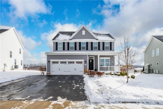 front of property featuring covered porch and a garage