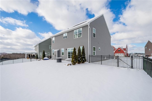 view of snow covered rear of property