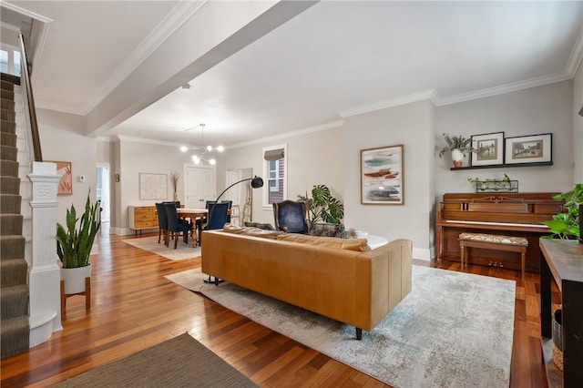 living room featuring a chandelier, light wood-type flooring, and ornamental molding