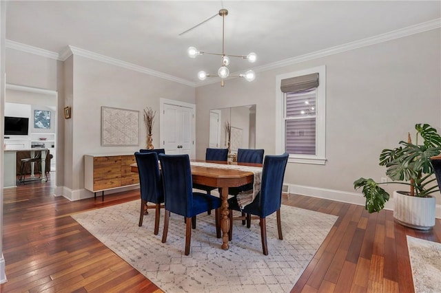 dining area featuring dark hardwood / wood-style floors, ornamental molding, and a chandelier