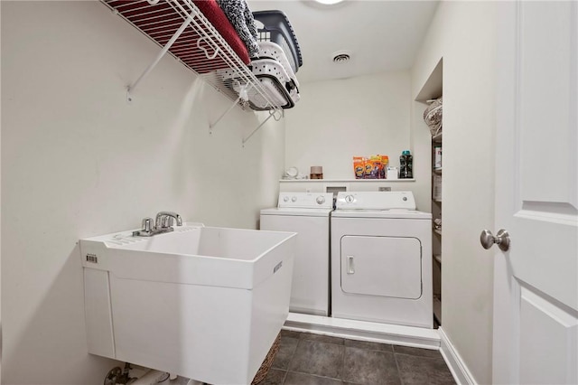 clothes washing area with washing machine and dryer and sink