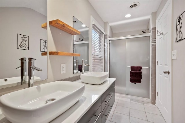 bathroom featuring tile patterned flooring, vanity, and an enclosed shower