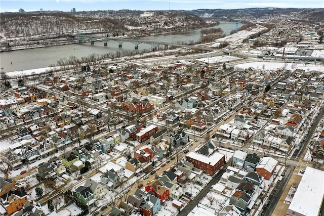 snowy aerial view with a water view