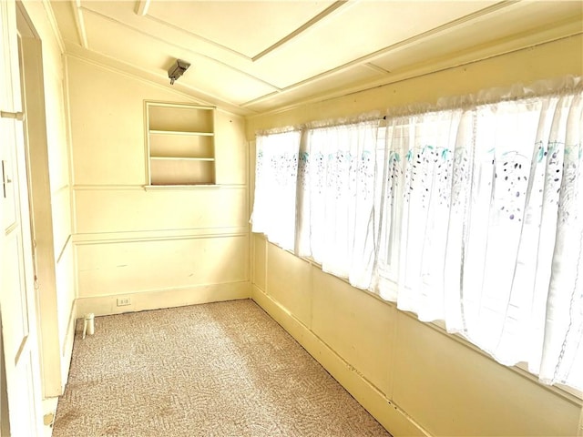 unfurnished sunroom featuring vaulted ceiling