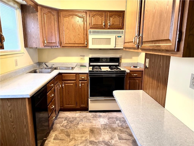 kitchen featuring sink, range, and black dishwasher