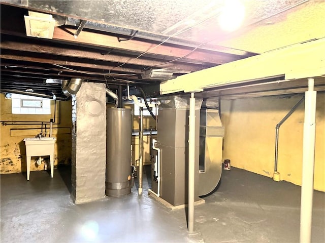 basement with heating unit, water heater, and sink