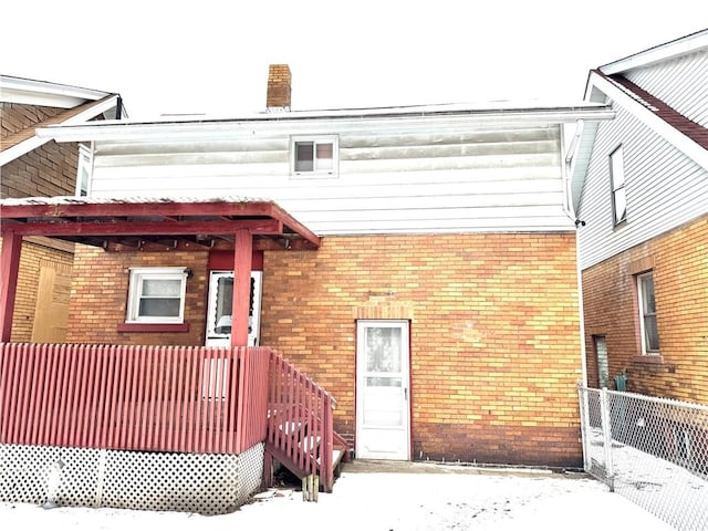 view of snow covered rear of property