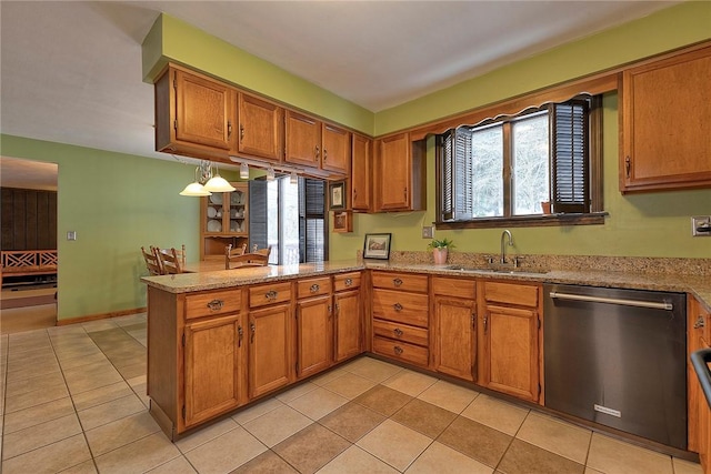 kitchen with kitchen peninsula, light stone countertops, stainless steel dishwasher, sink, and light tile patterned floors