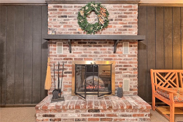 details featuring wooden walls and a fireplace