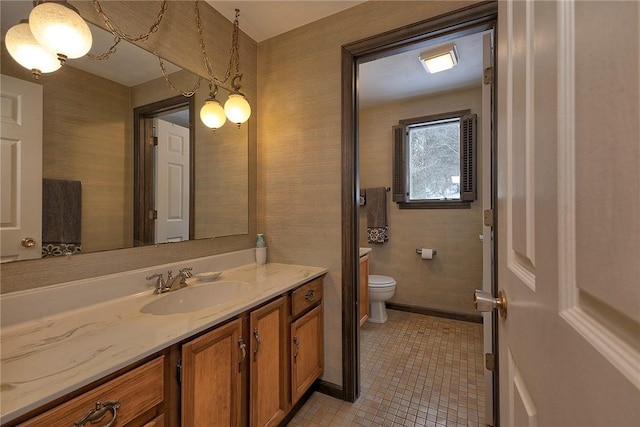 bathroom with tile patterned flooring, vanity, and toilet