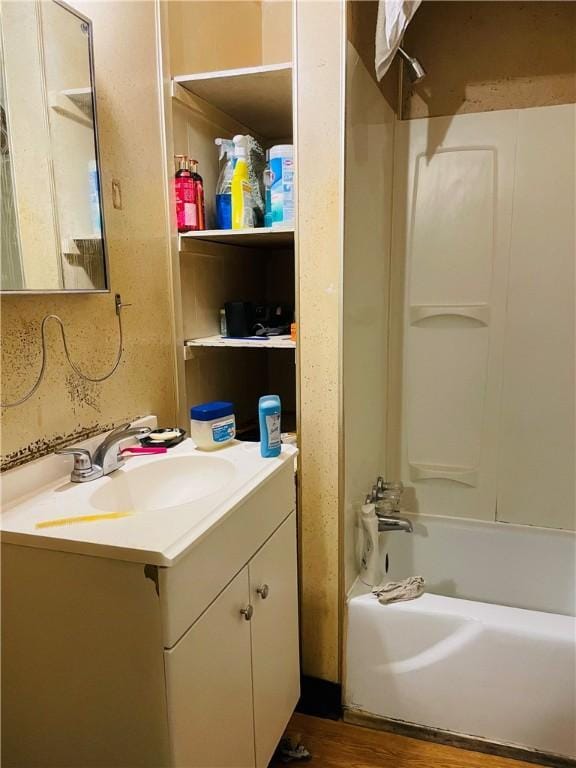 bathroom featuring shower / bathing tub combination, vanity, and hardwood / wood-style floors