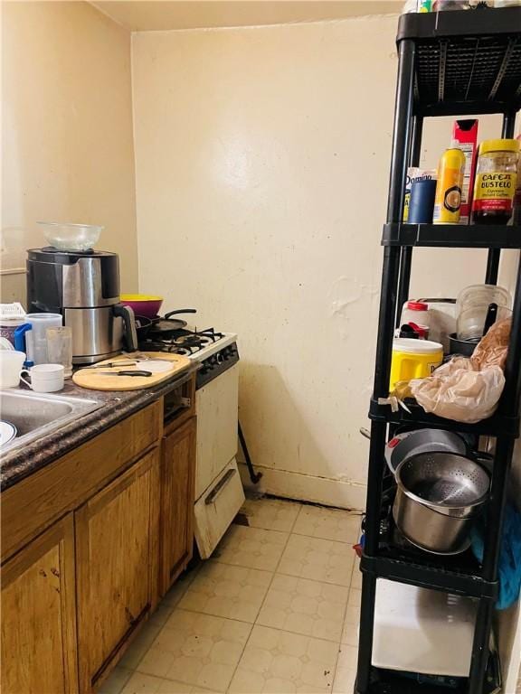 kitchen with white range with gas stovetop