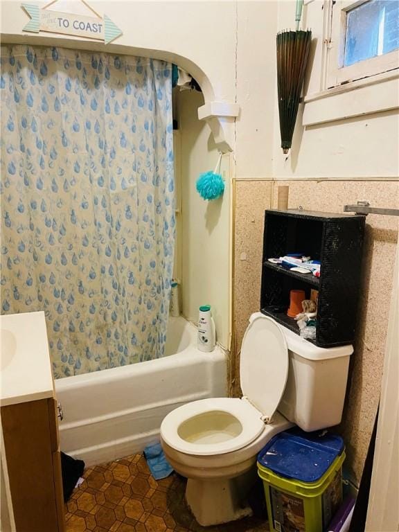 full bathroom with tile patterned floors, vanity, shower / bath combo, and toilet