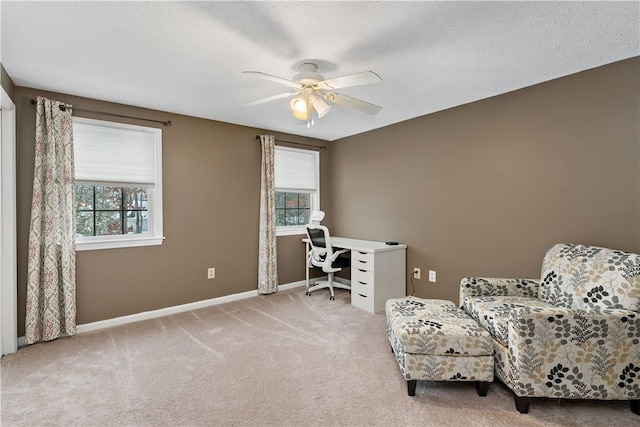 carpeted office featuring ceiling fan