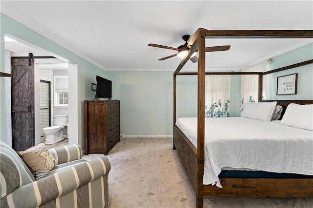 bedroom featuring ceiling fan, a barn door, crown molding, ensuite bathroom, and light carpet