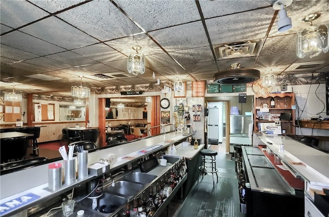 kitchen featuring a paneled ceiling and white refrigerator