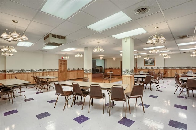 dining area featuring a drop ceiling