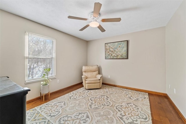 sitting room featuring hardwood / wood-style floors and ceiling fan