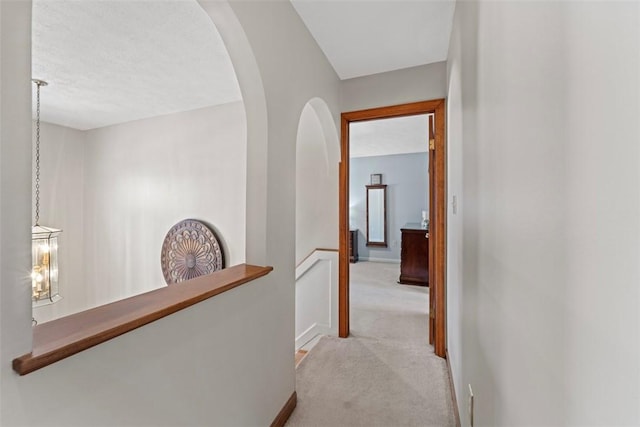 hallway featuring light carpet