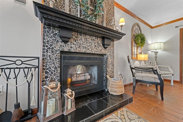 interior details with hardwood / wood-style flooring, ornamental molding, and a tiled fireplace