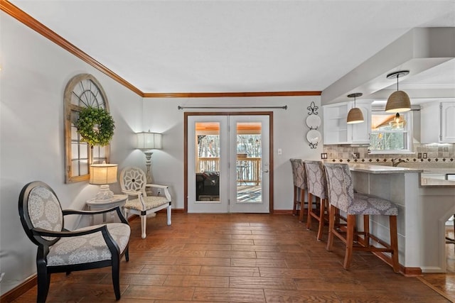 interior space with ornamental molding, plenty of natural light, and dark wood-type flooring