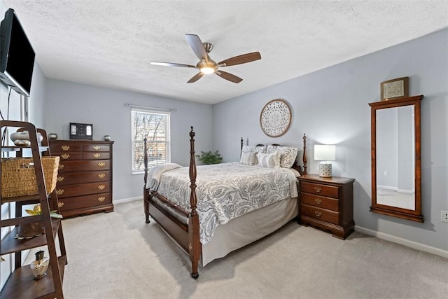 carpeted bedroom featuring a textured ceiling and ceiling fan