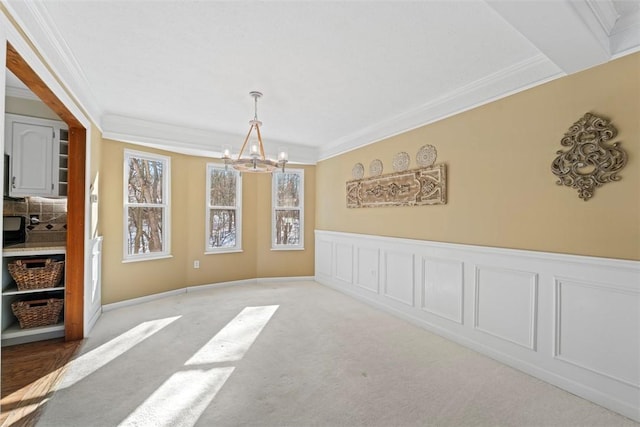 carpeted dining space with crown molding and a chandelier