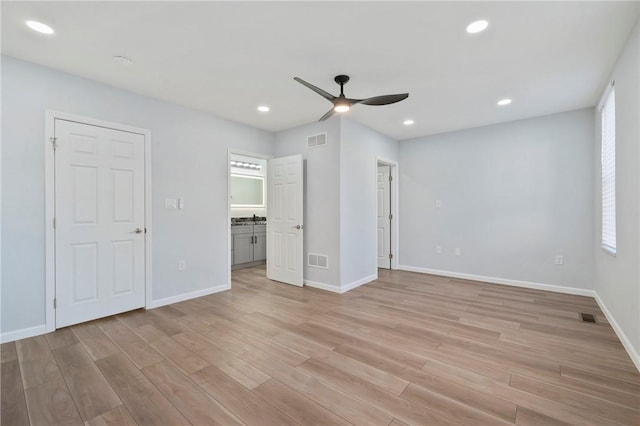 unfurnished bedroom with ceiling fan, multiple windows, and light hardwood / wood-style flooring