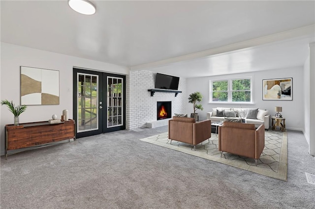 living room featuring light carpet, a fireplace, and french doors