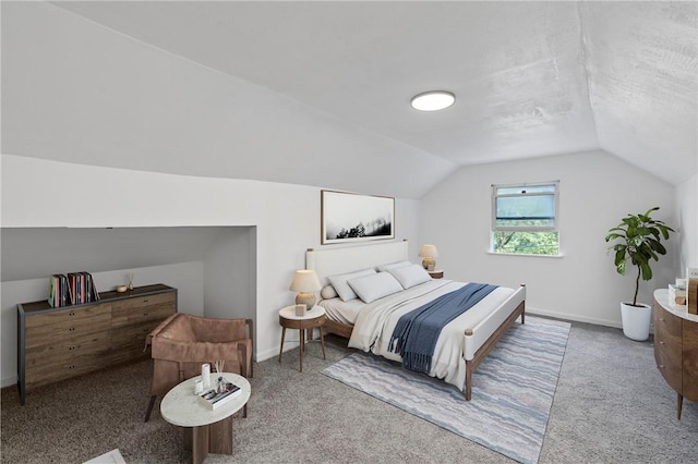 carpeted bedroom with vaulted ceiling