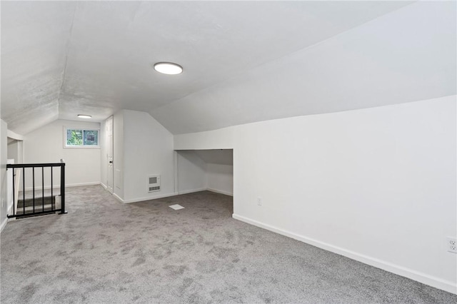 additional living space with light carpet and lofted ceiling