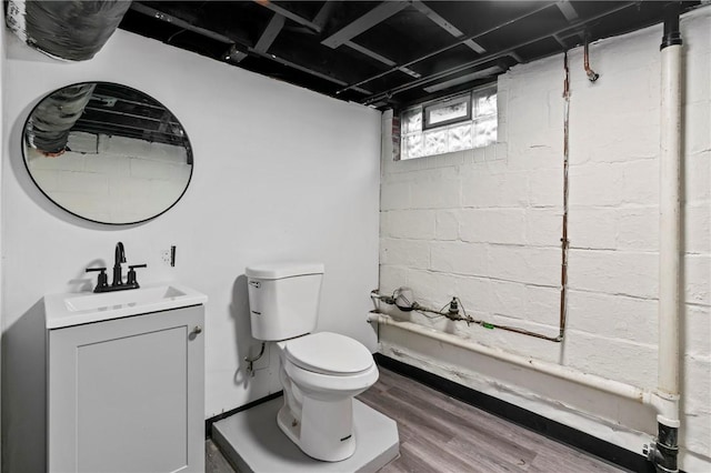 bathroom featuring hardwood / wood-style floors, vanity, and toilet