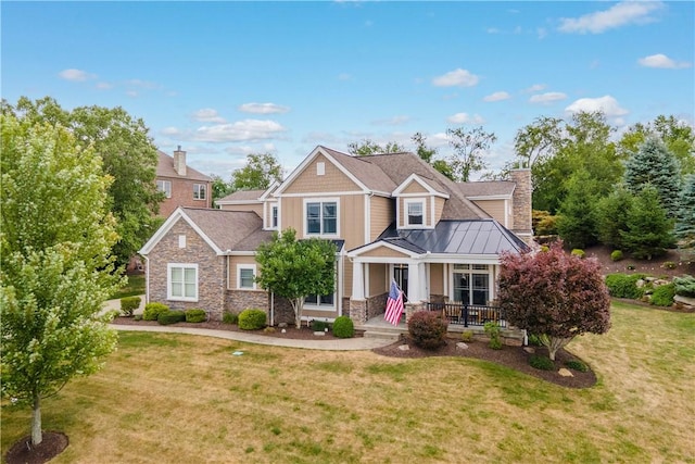 craftsman-style home with a porch and a front yard