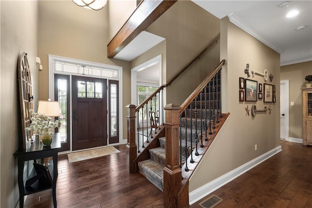 foyer featuring crown molding and dark wood-type flooring