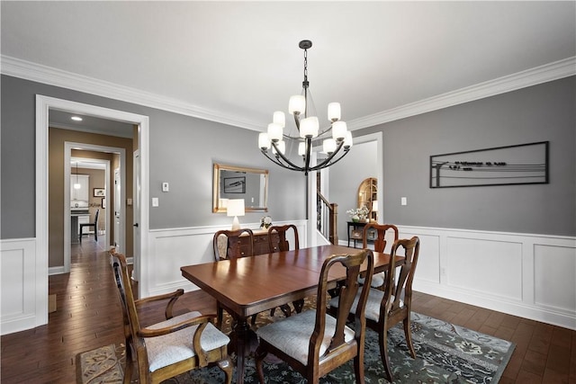 dining space featuring a chandelier, dark hardwood / wood-style flooring, and ornamental molding