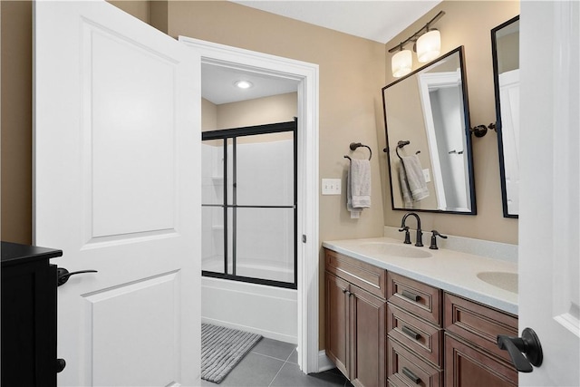 bathroom featuring tile patterned floors, vanity, and combined bath / shower with glass door