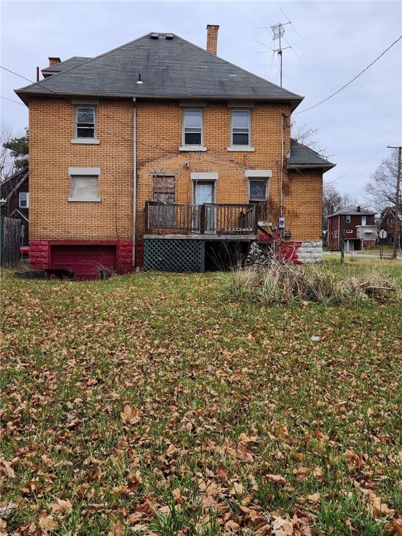 back of property featuring a yard